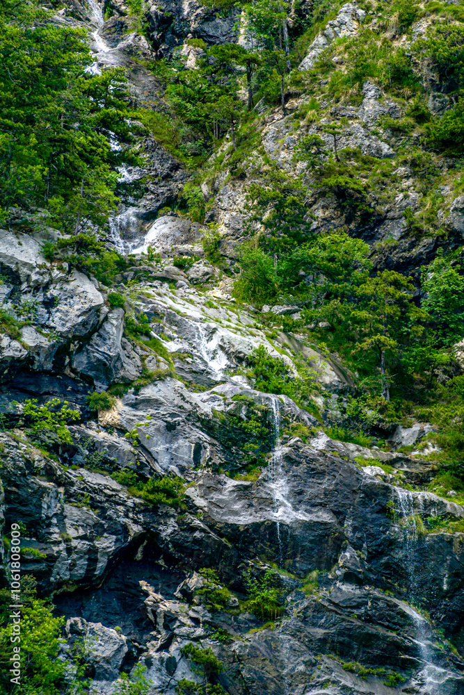 A Serene Mountain Waterfall Gently Cascades, Completely Surrounded by Lush Greenery and Nature A Serene Mountain Waterfall Gently Cascades, Completely Surrounded by Lush Greenery and Nature