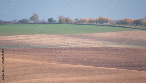 Stunning undulating arable agricultural landscape, photographed in autumn in south Moravia in the Czech Republic. The area is known as Moravian Tuscany and is full of rolling hills used for farming. photo