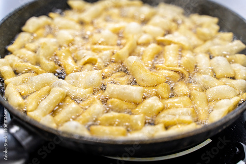 The dough is fried in pieces in a pan in oil (Pa Thong Ko), Baursaks or chak chak is a traditional national dish. photo