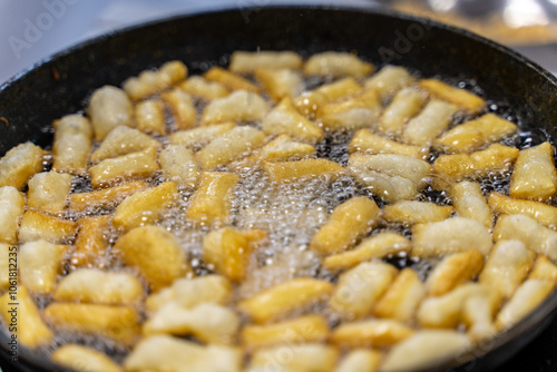 The dough is fried in pieces in a pan in oil (Pa Thong Ko), Baursaks or chak chak is a traditional national dish. photo