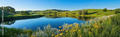 A tranquil morning along the Missouri River with wildflowers blooming under bright blue skies in late spring