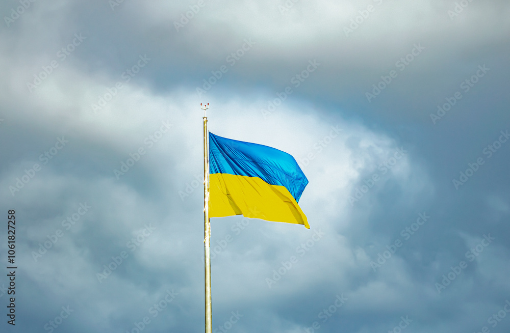 The flag of Ukraine against the background of a dark sky in windy weather. The flag of Ukraine against the background of a dark sky in windy weather.