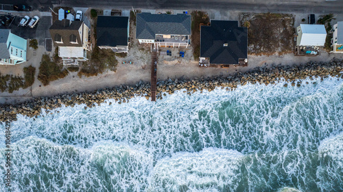 Aerial view of coastal residential properties vulnerable to climate change effects, facing rising insurance costs and increased risk from hurricanes and natural disasters.