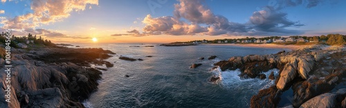 A breathtaking sunset over the tranquil waters and rocky shores of Kennebunkport, showcasing picturesque coastal beauty