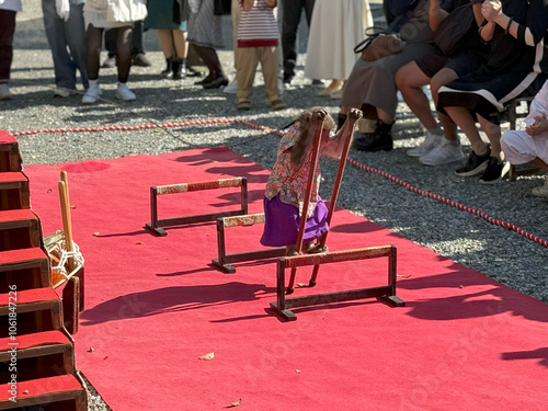 Photography Trained monkey performing tricks on a red carpet in front of an audience at an o
