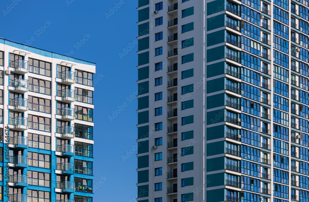 Fototapeta premium City view on a sunny day. Modern buildings, walls and windows. 