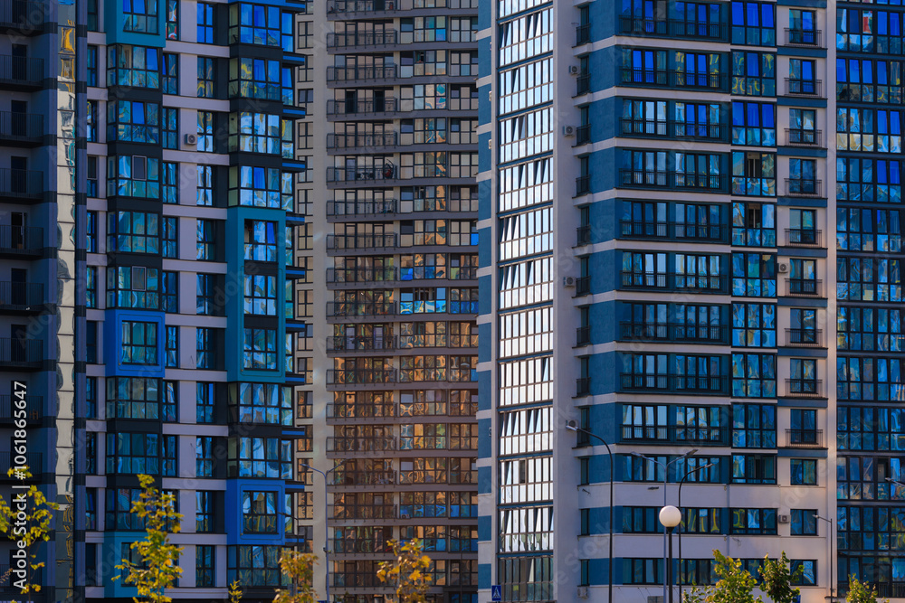 Fototapeta premium Modern buildings, walls and windows. City view on a sunny day. 