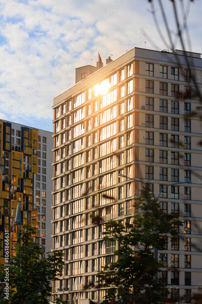 Modern buildings, walls and windows, reflections and sun rays. City view on a sunny day. Modern buildings, walls and windows, reflections and sun rays. City view on a sunny day.
