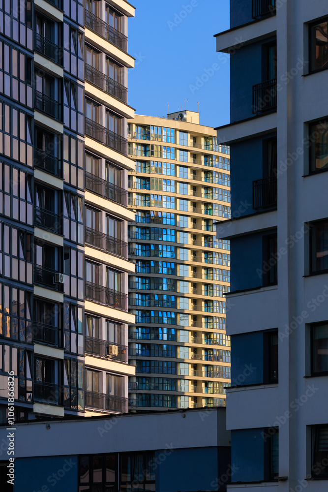 Fototapeta premium City view, modern buildings and skyscrapers against the blue sky.