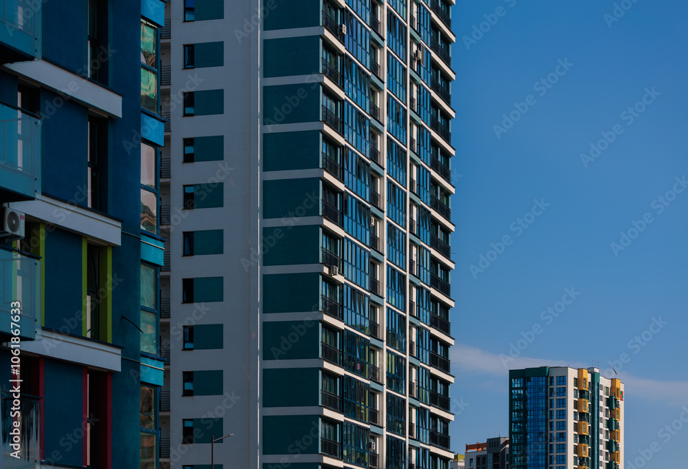 Fototapeta premium City view, modern buildings and skyscrapers against the blue sky.