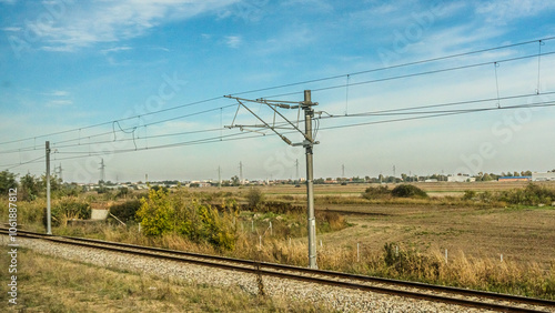 Agricultural fields with young green shoots of grain crops and plowed field without sowing. With trees in the background on the hills. Fallow concept. Alternation.