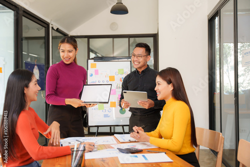 Group of Asian businessmen are sitting in a meeting, talking, exchanging knowledge. Presentation about office work