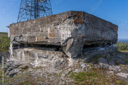 View of German WW2 bunker on mountain during summer with blue sky, Berlevag, Norway. photo