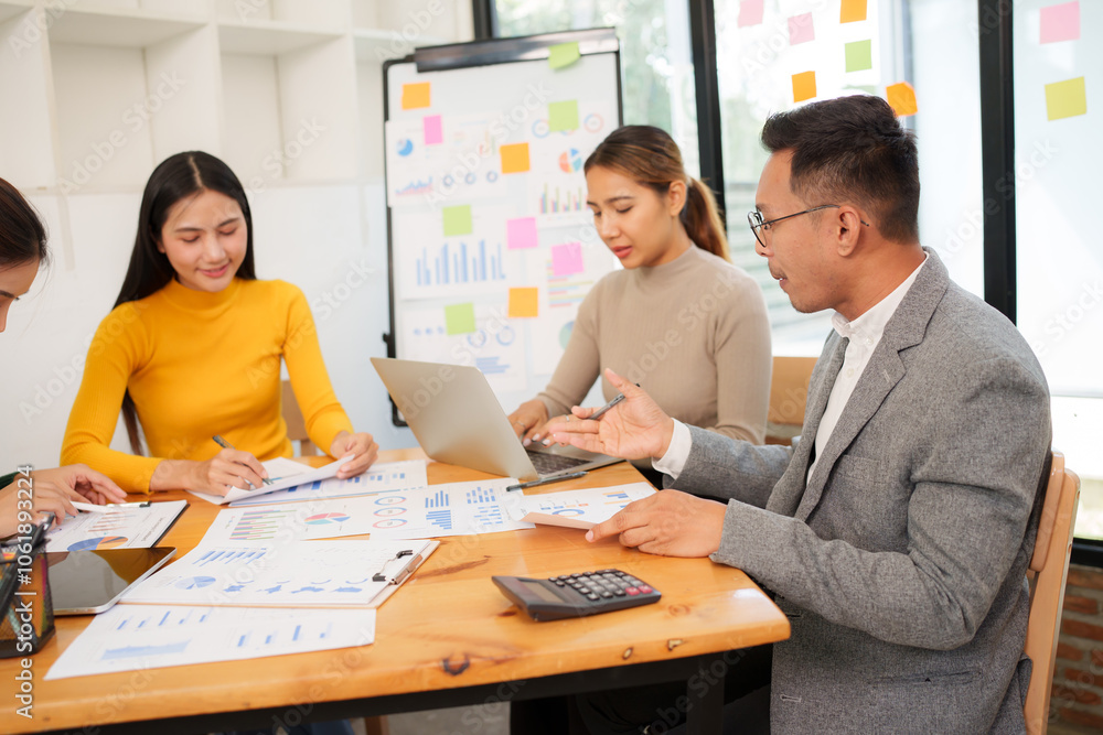 Group of Asian businessmen are sitting in a meeting, talking, exchanging knowledge. Presentation about office work Group of Asian businessmen are sitting in a meeting, talking, exchanging knowledge. Presentation about office work