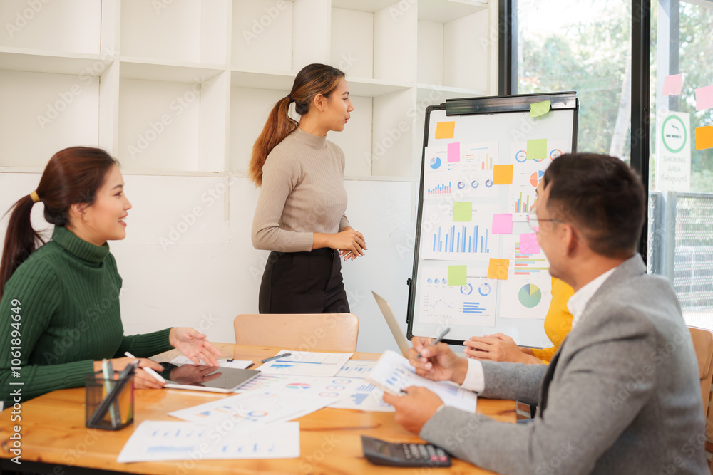 Asian Business Group Chat about graph work Present in meetings, in the office Asian Business Group Chat about graph work Present in meetings, in the office