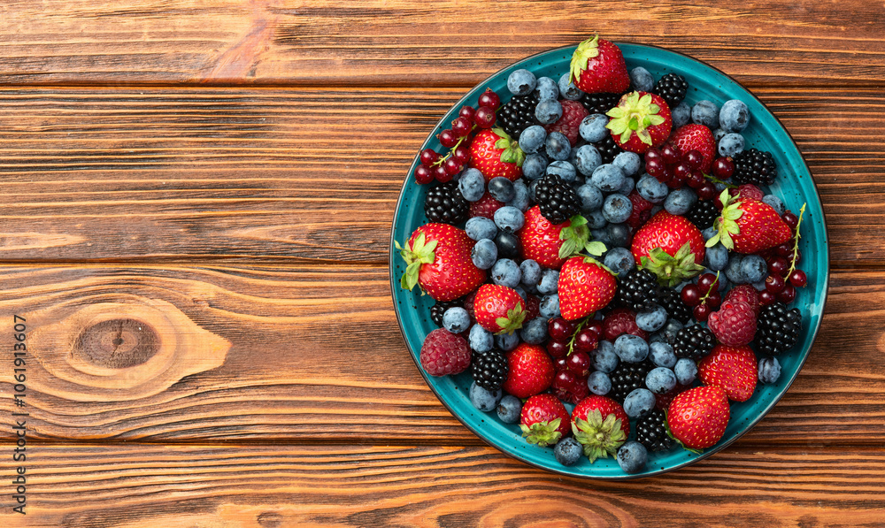Mix of ripe colorful berries in bowl photography . Blueberry , strawberry , raspberry , blackberry and red currant . Top view Mix of ripe colorful berries in bowl photography . Blueberry , strawberry , raspberry , blackberry and red currant . Top view
