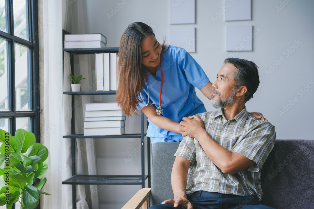 Fototapeta premium Young nurse provides compassionate care to a senior man at his home, offering comfort and support during a challenging time