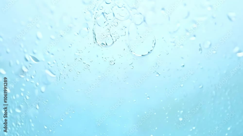 Raindrops on a window with a bright, soft blue sky in the background. 4k Video footage Raindrops on a window with a bright, soft blue sky in the background. 4k Video footage