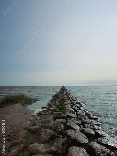 Long stone road on the sea