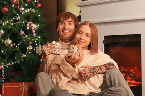 Happy young couple with cup...
