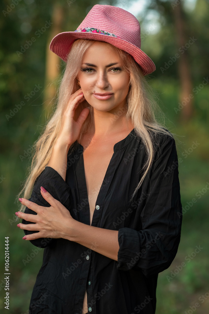 Portrait of a beautiful young blonde girl in a black shirt in the forest. Portrait of a beautiful young blonde girl in a black shirt in the forest.