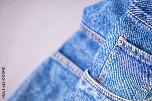 A denium blue jean pocket closeup with space for text. View of old jeans details. Denim background, texture photo