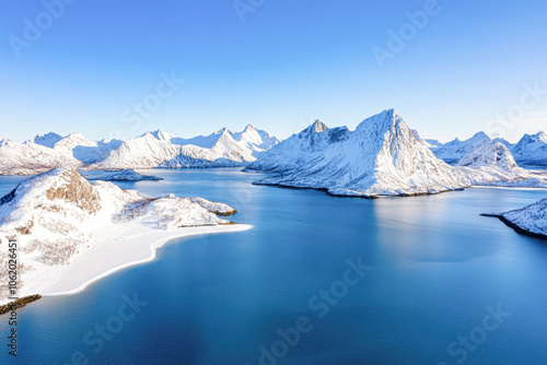 A beautiful blue ocean with snow-capped mountains in the background