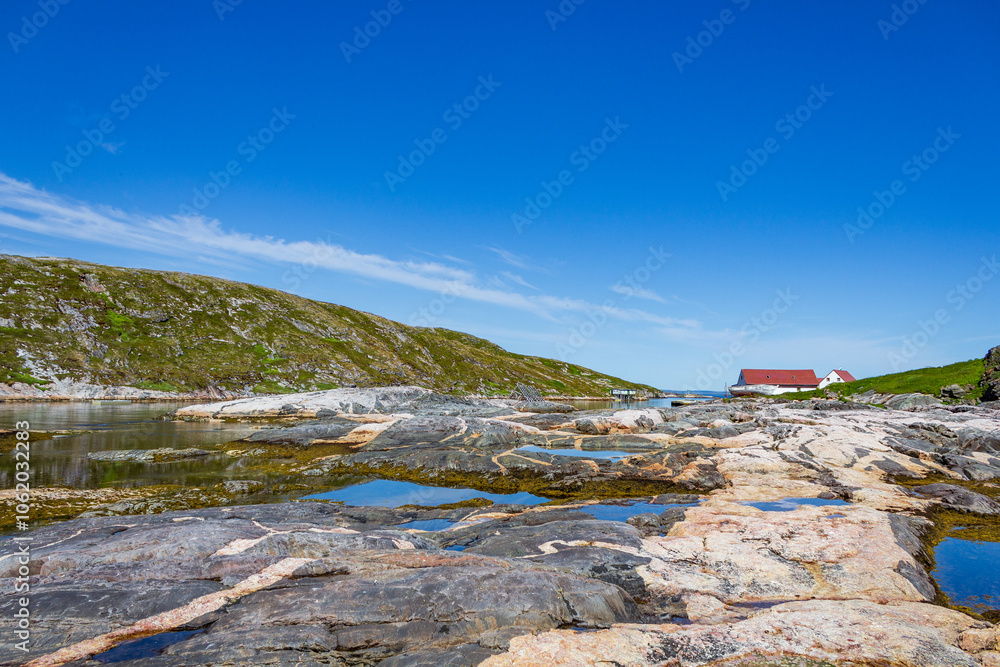 Tranquil Coastal Landscape With Clear Blue Sky and Cottages Tranquil Coastal Landscape With Clear Blue Sky and Cottages