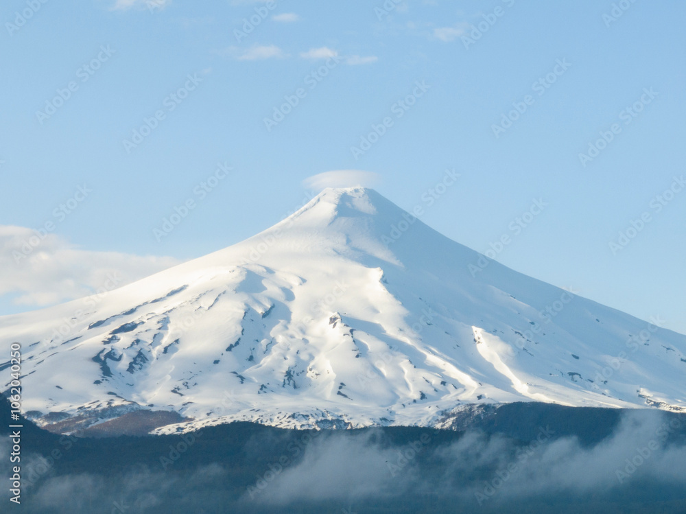 Snowy peak of Villarrica volcano on a sunny morning view Snowy peak of Villarrica volcano on a sunny morning view
