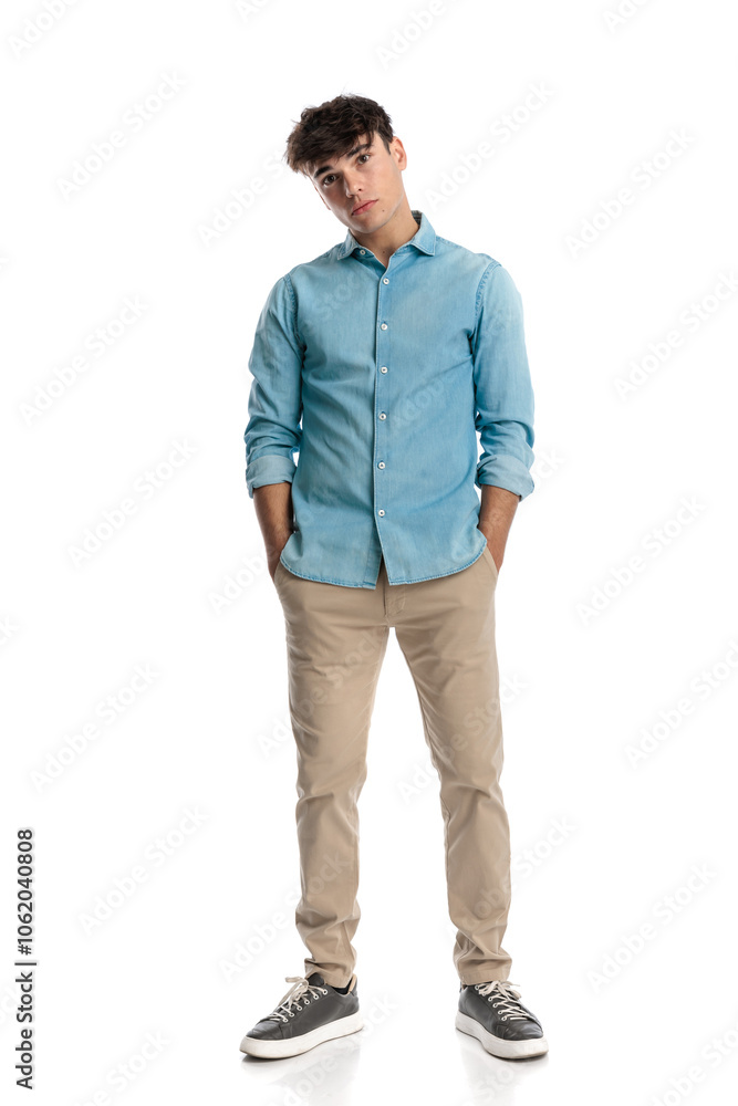 Fototapeta premium casual stylish man in blue denim shirt holding hands in pockets