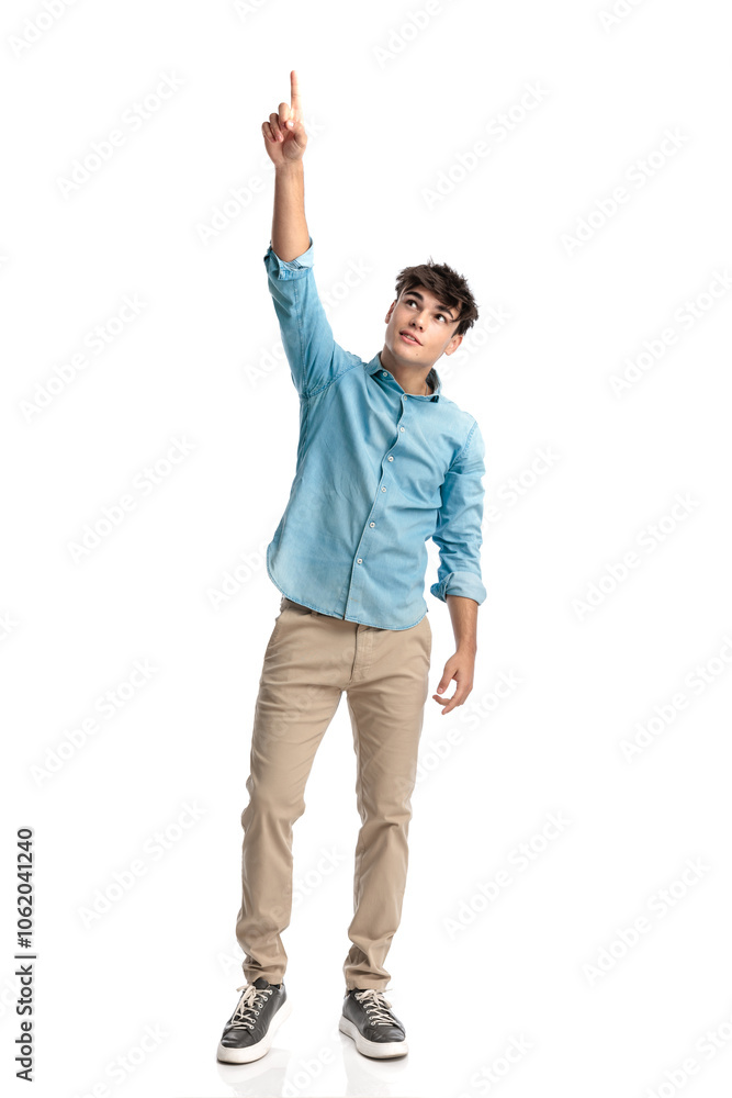young student in his 20s pointing finger up to the sky and being grateful young student in his 20s pointing finger up to the sky and being grateful