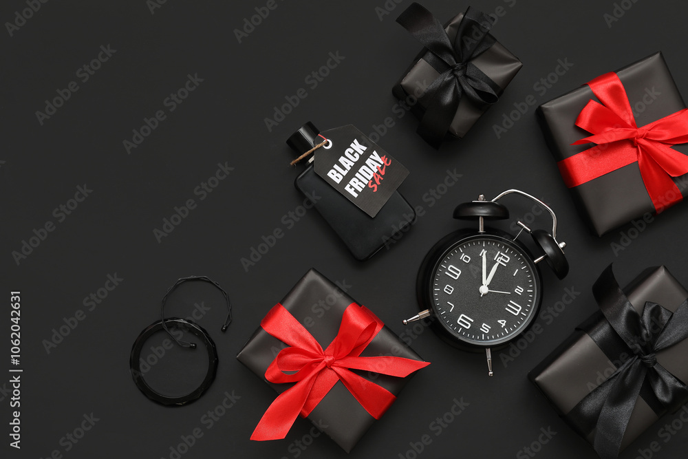 Composition with alarm clock, different gift boxes and perfume on dark background. Black Friday sale Composition with alarm clock, different gift boxes and perfume on dark background. Black Friday sale