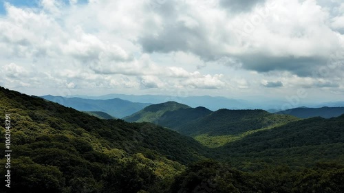 Majestic Mountain Layers with Pine Trees and Clouds - Serene Nature Landscape