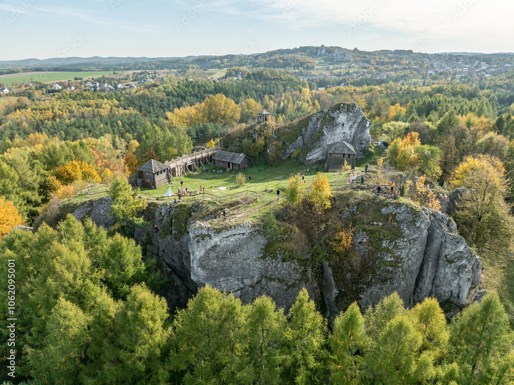 Obraz premium Aerial drone view of stronghold on Birow Hill. Reconstructed stronghold on Birow Hill in Podzamcze, Ogrodzieniec, Poland. Limestone rock hill in autumn.