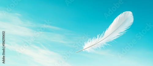  A white feather drifting against a blue sky, surrounded by fluffy clouds