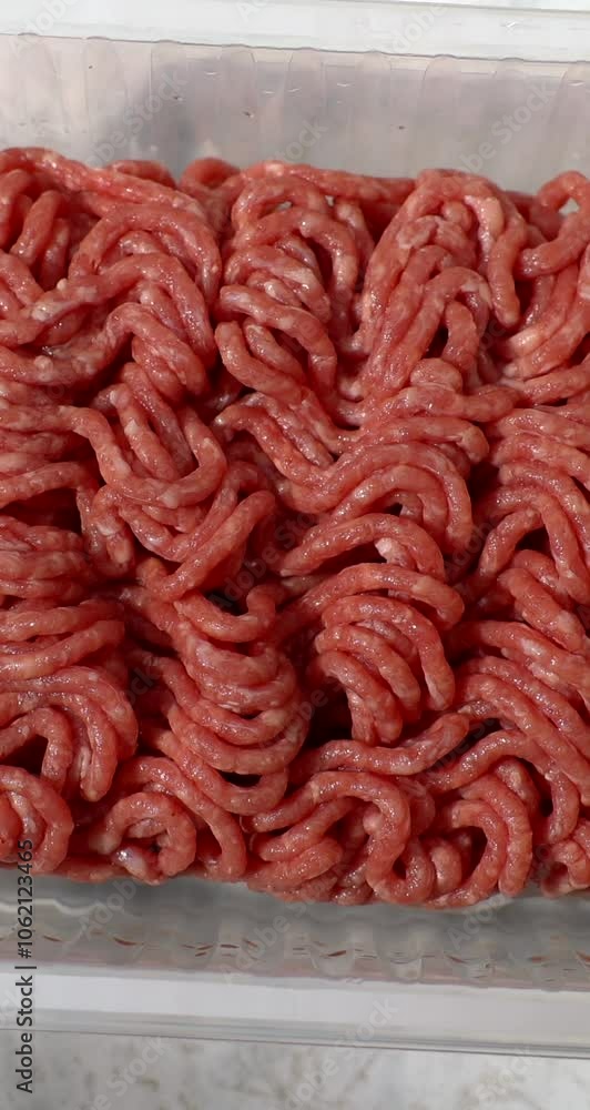 Minced meat, beef mince, forcemeat, fresh raw uncooked ground meat close up, rotating background. Vertical video content for social networks Minced meat, beef mince, forcemeat, fresh raw uncooked ground meat close up, rotating background. Vertical video content for social networks