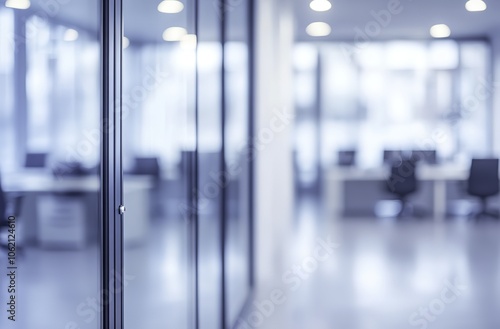 Blurry office space with a modern glass door