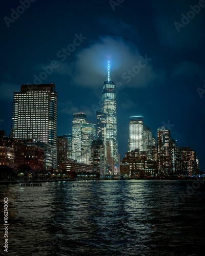 The illuminated skyline of New York City at night from Pier 34 at Hudson River Park, Manhattan, New York