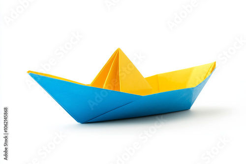 Blue and yellow origami boat on a white background photo