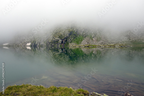 Mountain lake with fog, Alps, Europe