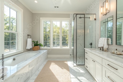 Modern bathroom interior design featuring marble surfaces and natural light