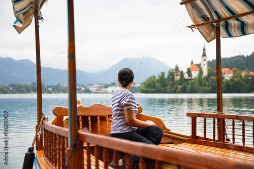 Tourists woman on a traditional 'pletna' wooden boat photo