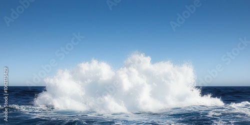 Majestic ocean waves crashing against each other under a clear blue sky.