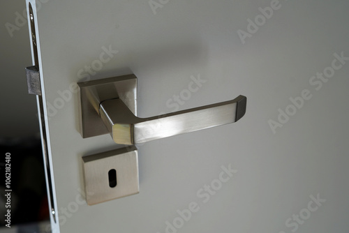 Chrome interior door fittings. We see the handle by the keyhole.
