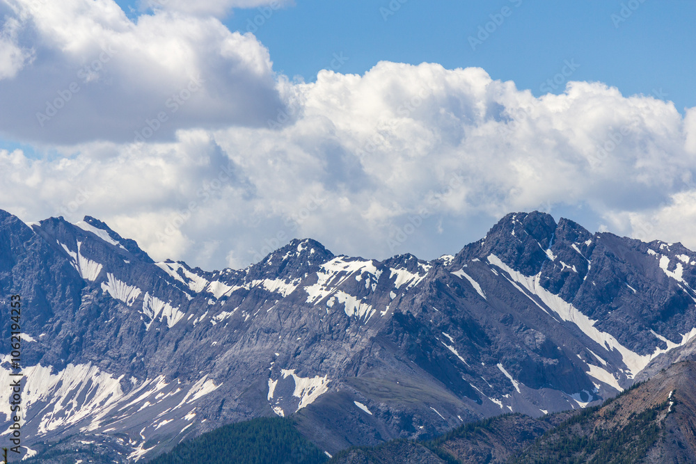 Majestic Snow-Capped Mountains Under Cloudy Blue Sky Majestic Snow-Capped Mountains Under Cloudy Blue Sky