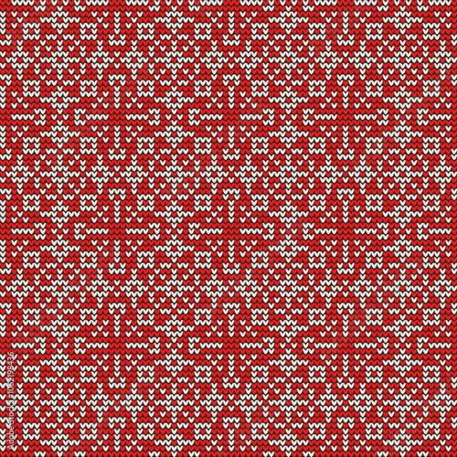 Red and white knitted geometric pattern. Flowers, snowflakes. Christmas seamless ornament. Traditional Fair Isle holiday background. Holiday sweater. Vector illustration.