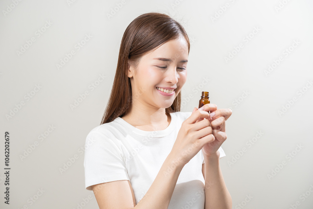 Aromatherapy, smile pretty asian young woman, girl enjoying smell fragrance of herbal from medicine natural organic essential perfume oil.Therapy treatment, beauty skin care isolated on background. Aromatherapy, smile pretty asian young woman, girl enjoying smell fragrance of herbal from medicine natural organic essential perfume oil.Therapy treatment, beauty skin care isolated on background.