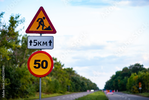 Road signs indicating construction work ahead, alerting drivers to detours and safety measures. Ideal for illustrating traffic management, urban development, or infrastructure projects. A vital image 