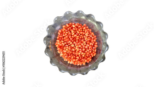 Pomegranate seeds that have been picked to be eaten fresh in glass bowl, isolated on white background