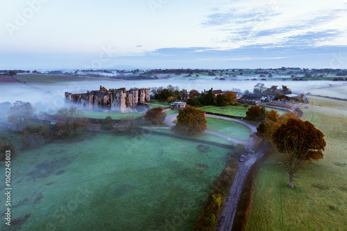 Raglan Castle in the fog at dawn, Monmouthshire, Wales, England photo